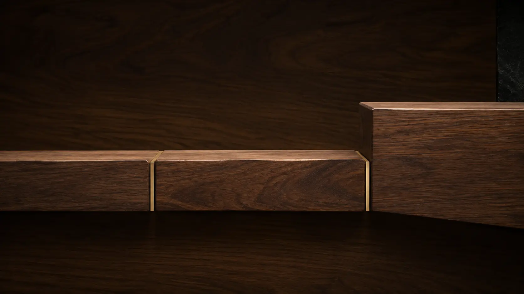 Linear walnut joinery with three precise brass divisions