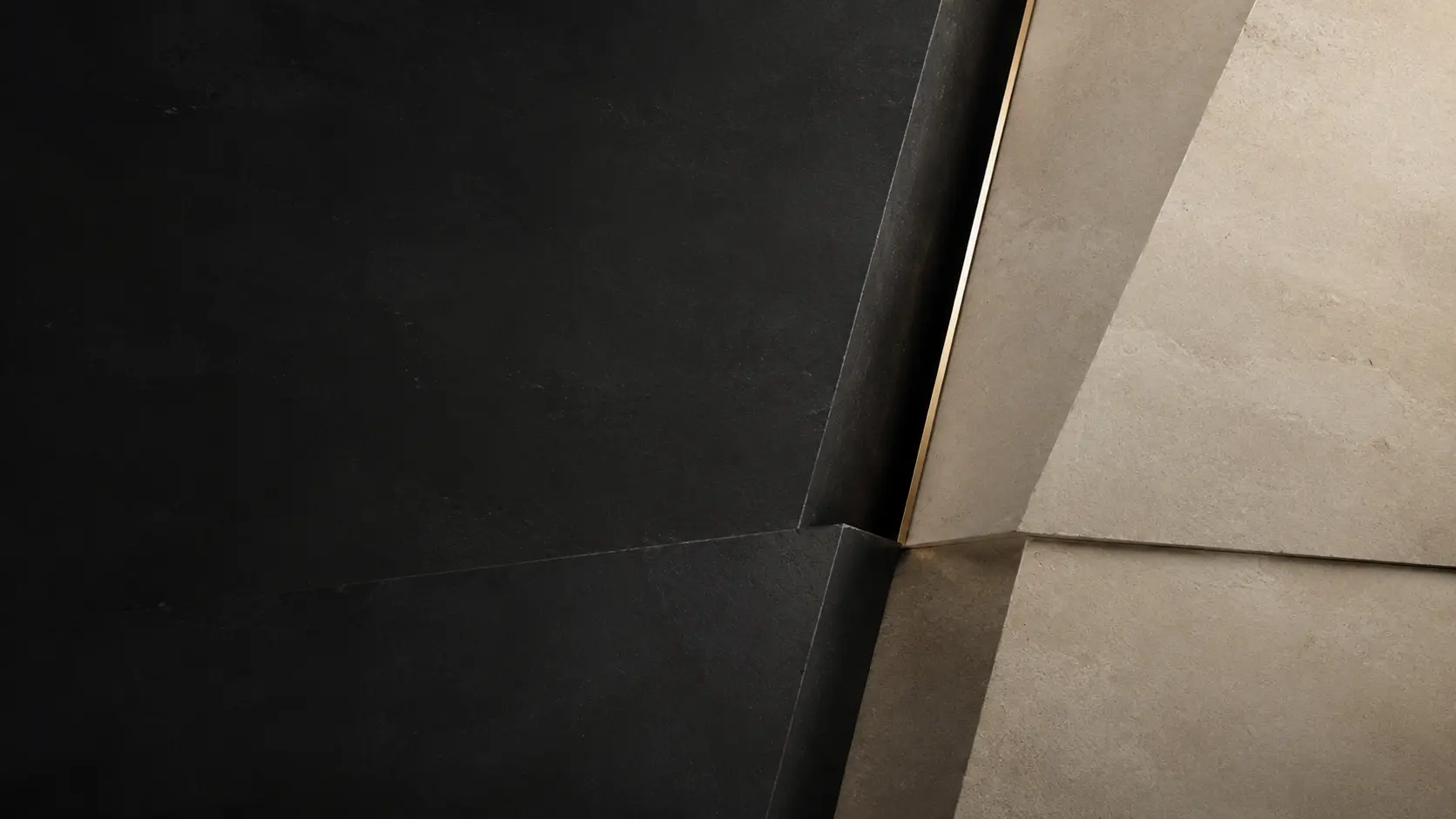 Walnut architectural wall opening into dark stone and warm light